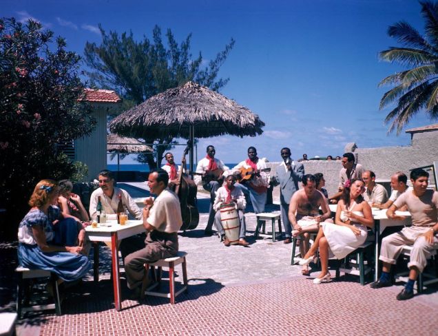 Guests-sit-at-outdoor-tables-in-the-Kastillito-Club-and-talk-together-while-a-band-performs-in-Varadero-Cuba.